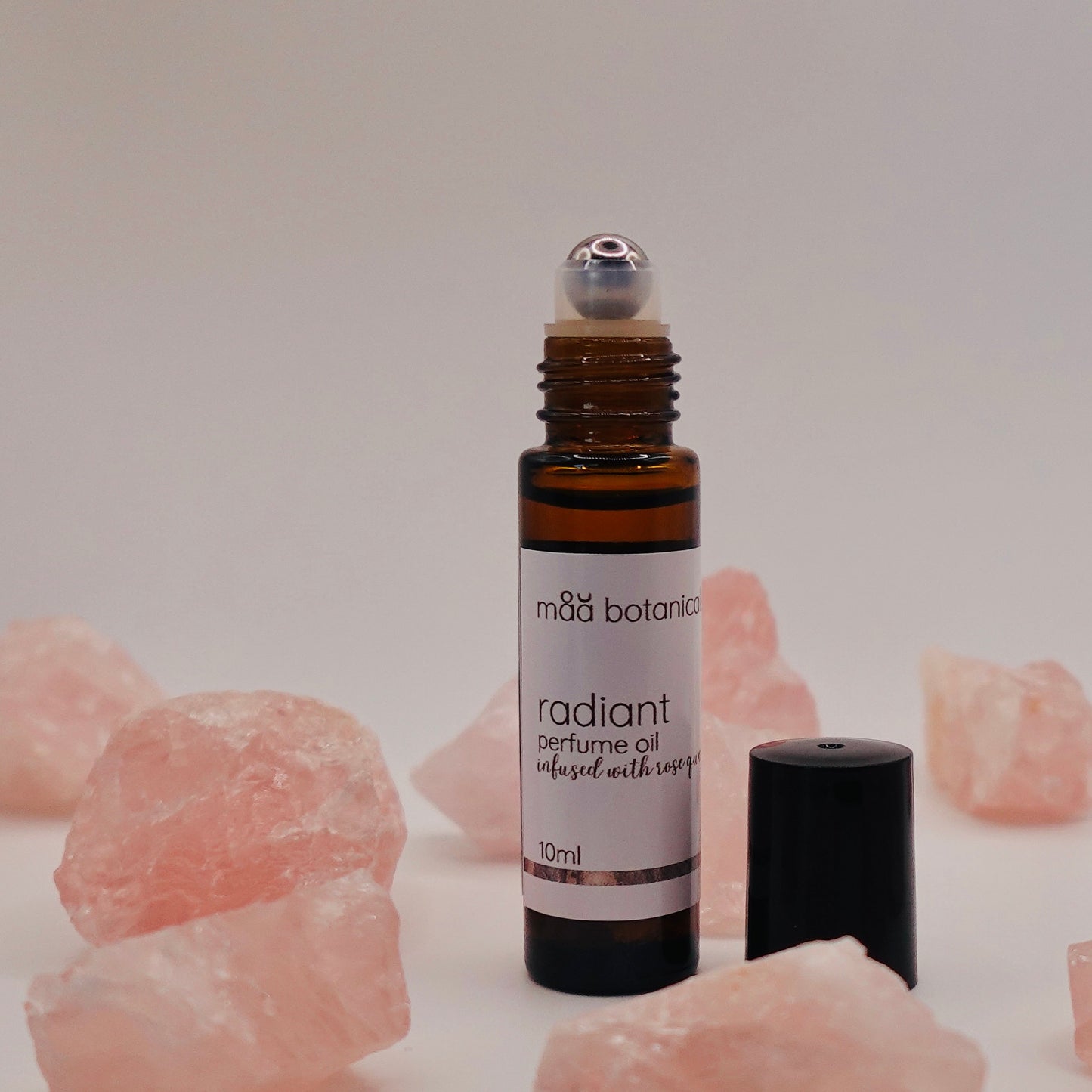 maa botanicals radiant roll-on perfume oil bottle lwith rose quartz crystals
