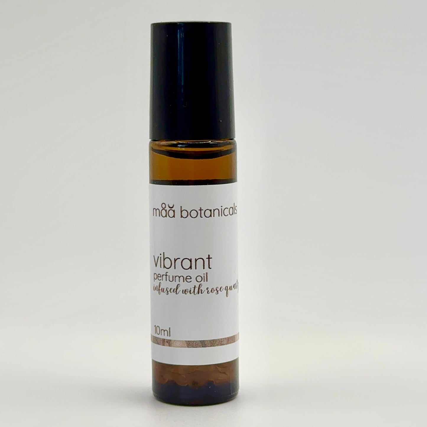 Roll-on bottle of 'Vibrant' perfume oil by maa botanicals on a white background