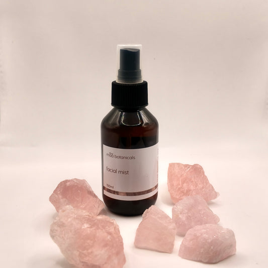 maa botanicals facial mist in a 100ml amber bottle with mist spray surrounded by rose quartz crystal
